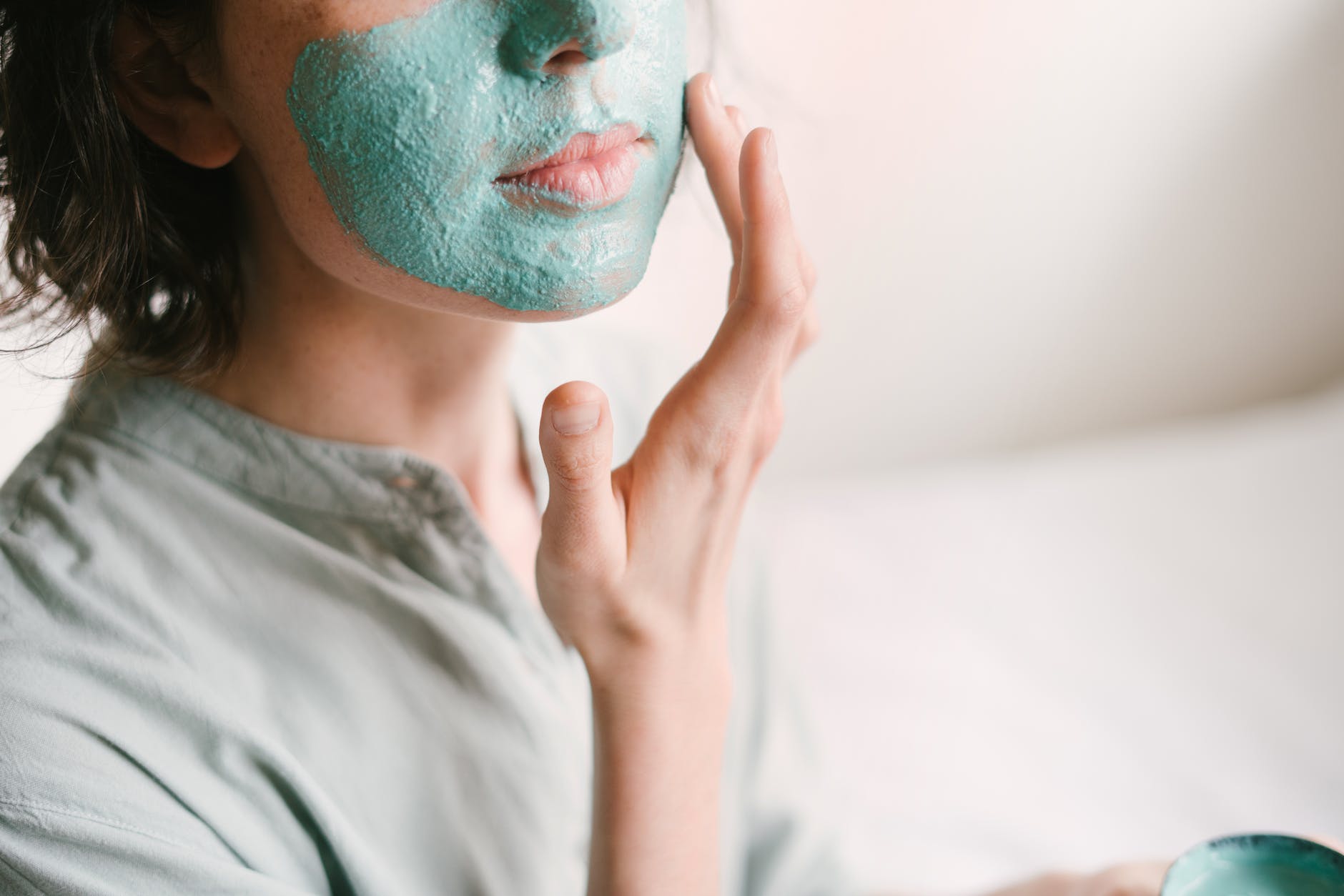 woman putting medicated cream on her face